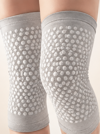 The Alaga knee support pair worn on both knees, showing the true fabric and massage dots